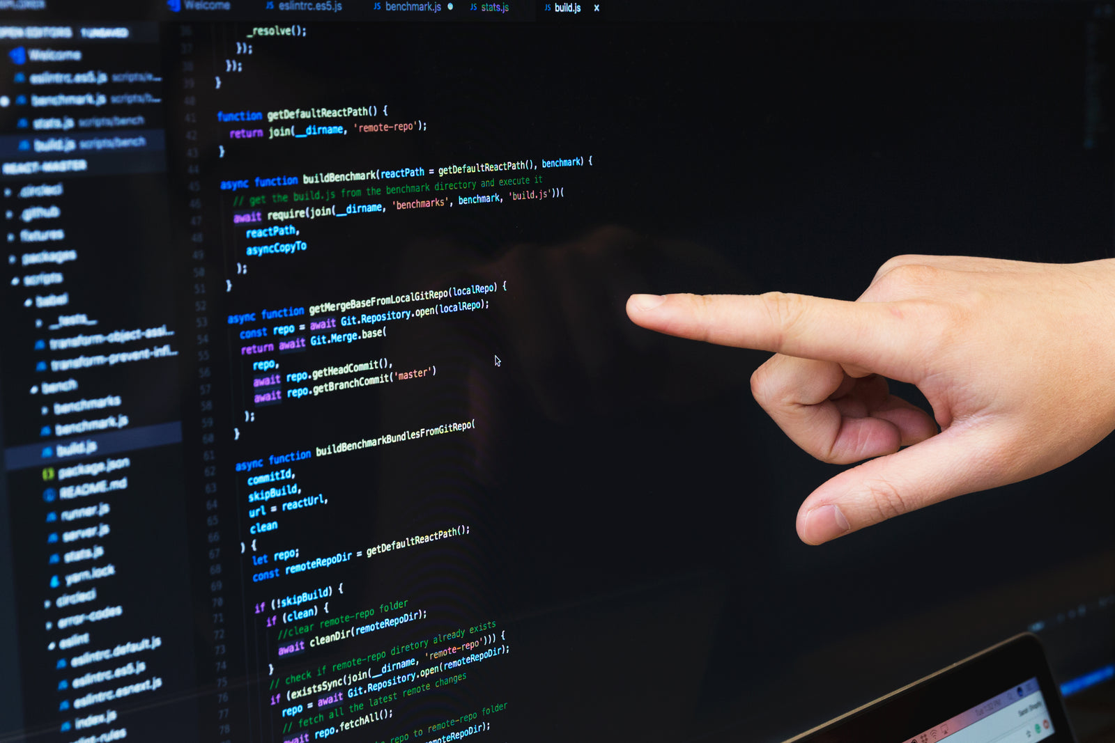 Developer reviewing JavaScript benchmark code on a monitor